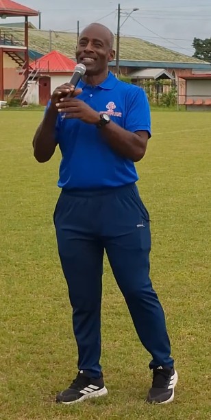 Mr. Gordon Maloney speaking at a football ground
